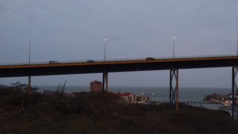 Camera-car-chase-over-the-the-Juliana-Bridge-enterance-of-the-Sint-Anna-Bay-and-a-cruise-ship-at-the-miga-pier-from-the-View-of-the-Deloitte-Dutch-Caribbean-Parking-lot-on-the-Curacao