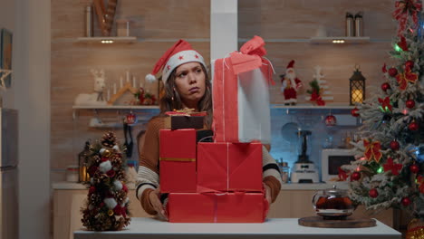 Festive-woman-putting-presents-on-kitchen-counter