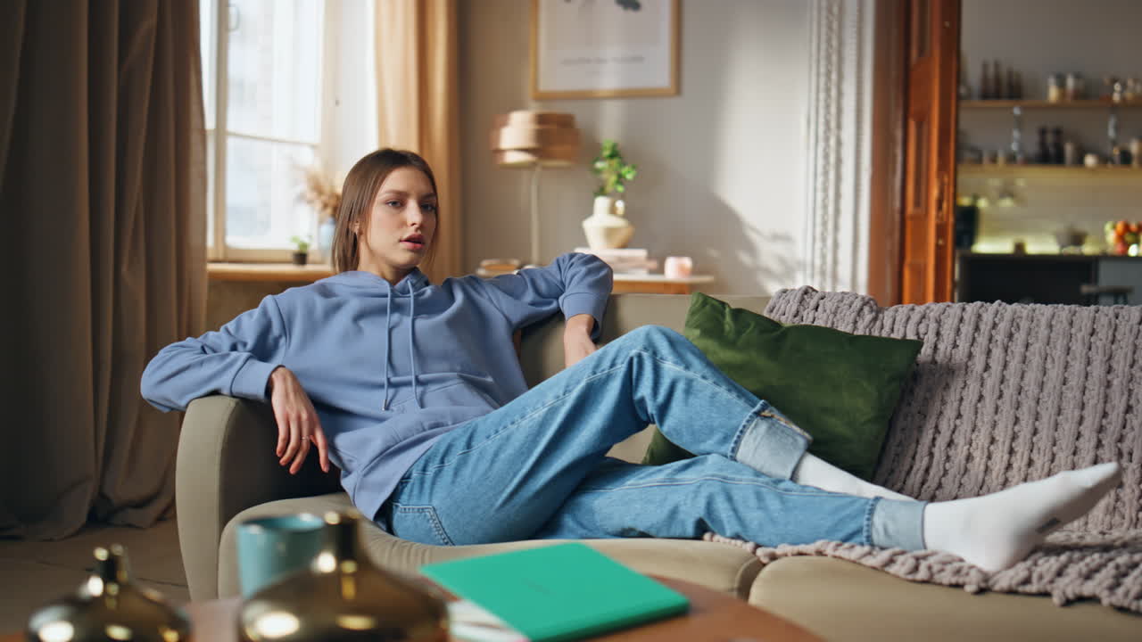 Woman relaxing on a couch in a living room