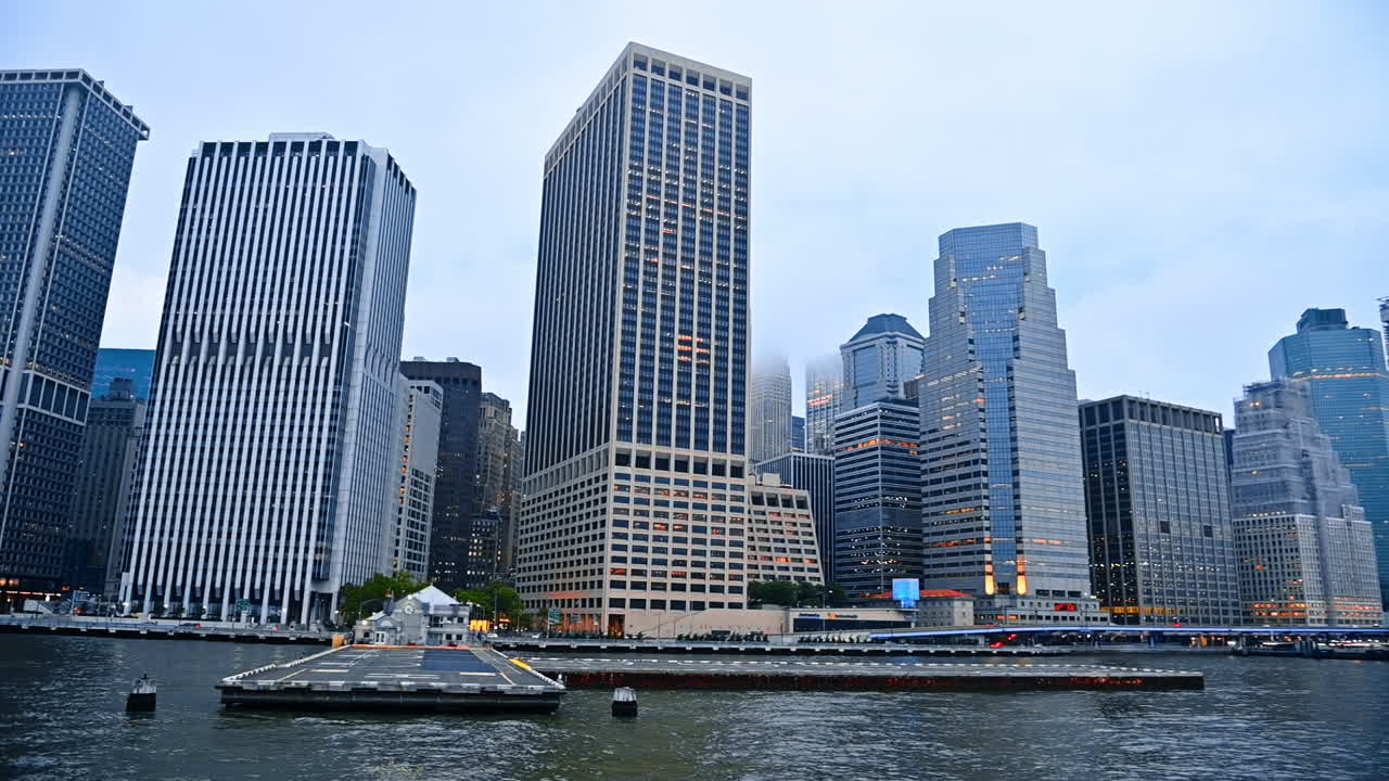Huge rectangular modern high-rises at the waterfront of the river. Architecture of New York, USA from the waterscape