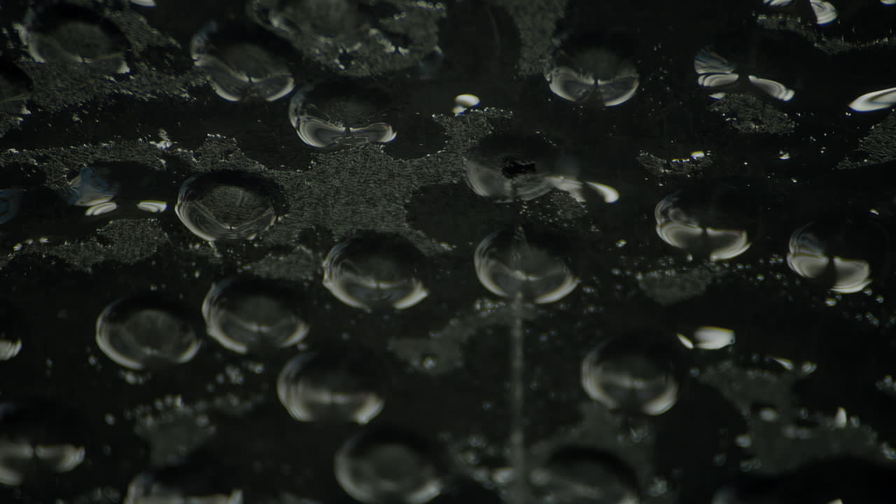 Dark cinematic close-up of water dripping from a leaking ceiling, with moody lighting, murky shadows, and atmospheric detail evoking mystery, decay, and haunting urban beauty