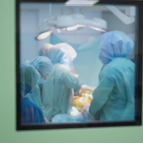 medical team performing surgical operation in bright modern surgery room. operating theatre. modern equipment in clinic