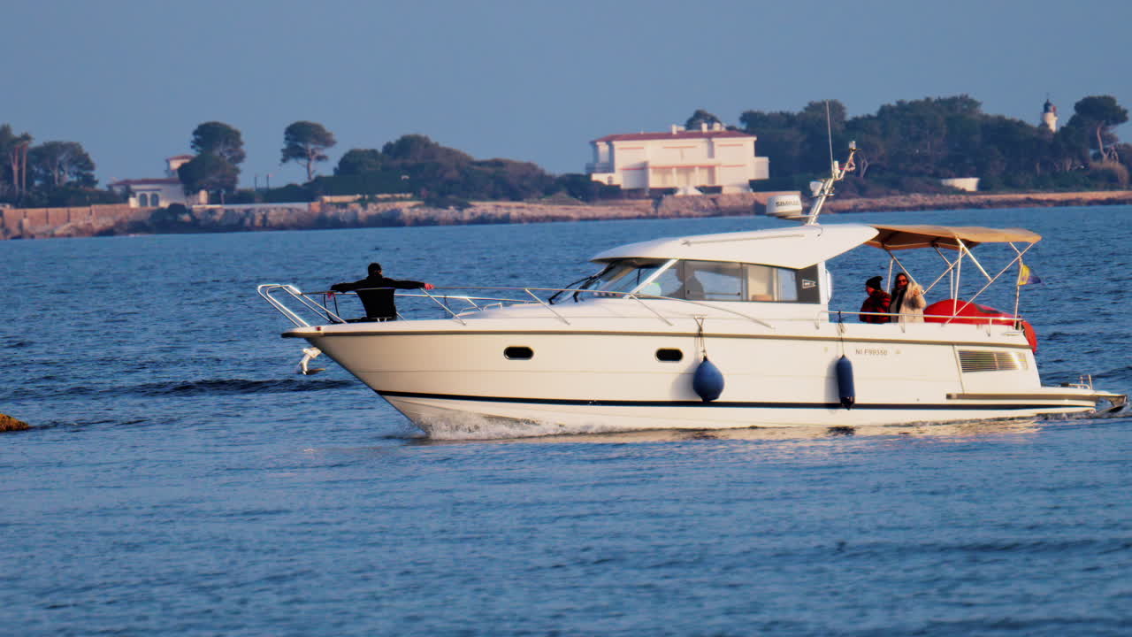 Antibes, France - February 14, 2025: People riding on a sailboat on a cloudy day