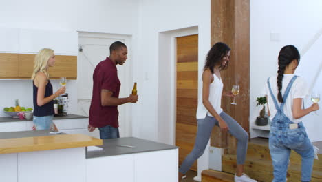 Friends-Sitting-Down-At-Table-For-Dinner-Party-At-Home-Together