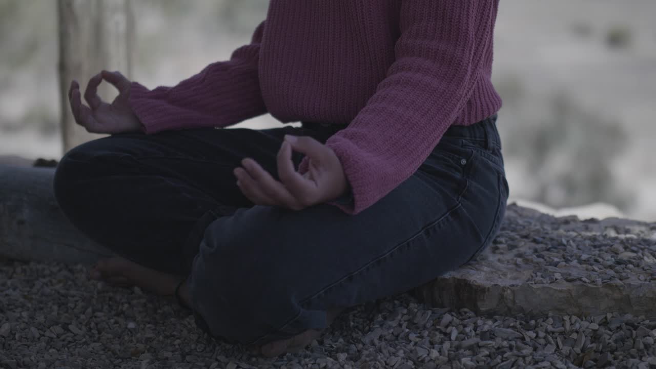 Person meditates in shadow in natural landscape of Israel