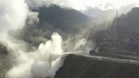 Camera-approaches-the-rushing,-dramatic-waterfall-of-the-Hidroituango-dam-on-the-Cauca-river,-in-Ituango,-Colombia