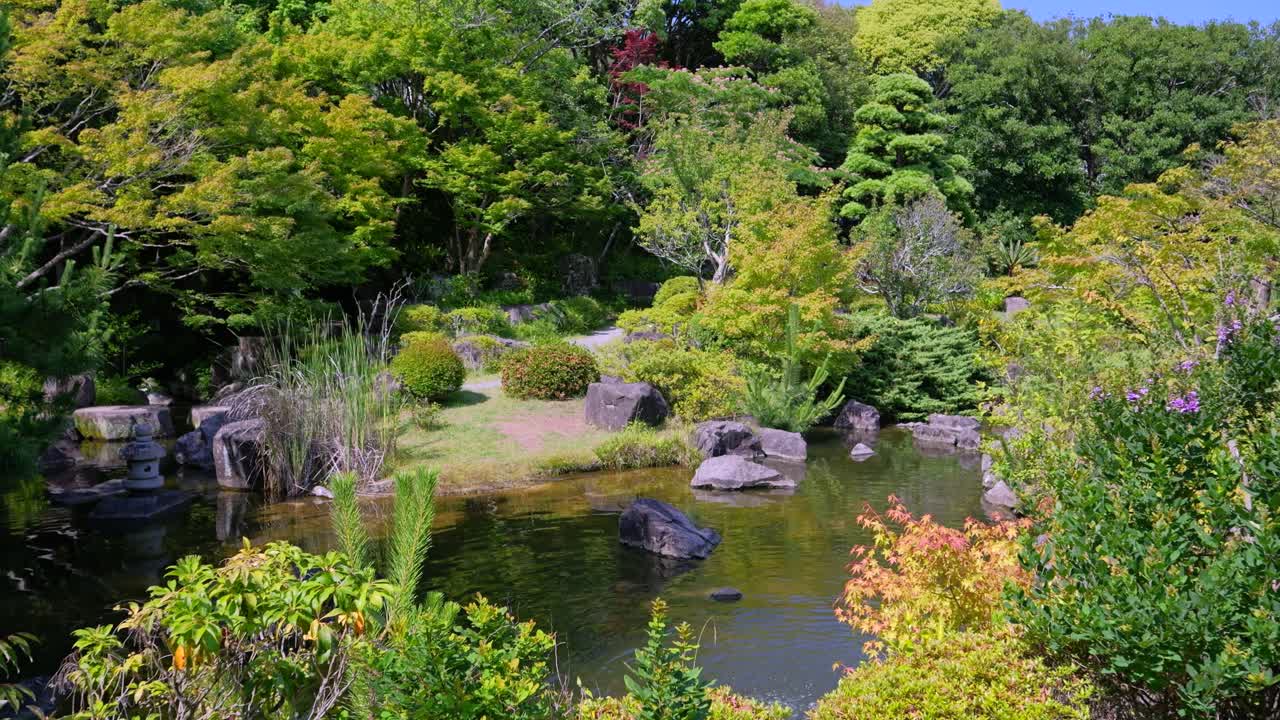 Tranquil Japanese Garden with Pond and Lush Greenery
