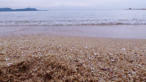 a peaceful morning on the beach with gentle waves lapping against the shore.