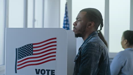 man voting at a polling place