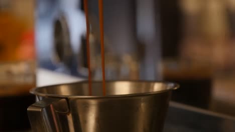 close-up of a double espresso pouring from the machine at a coffee shop