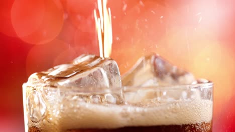 Glass-of-cola.-Ice-cola-with-splashing-bubbles-slow-motion-on-a-blurry-light-,blurry-background.