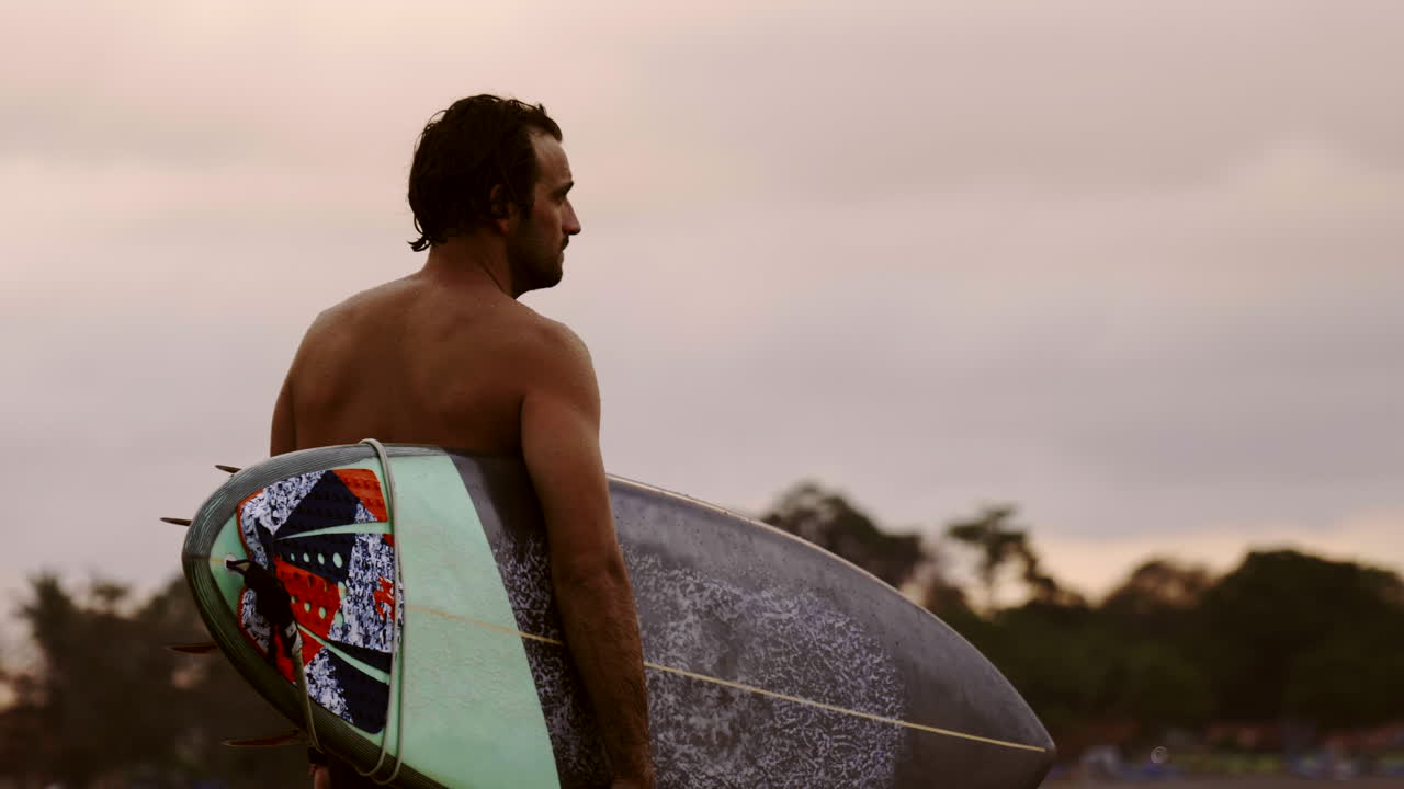 Surfer with Surfboard at Sunset