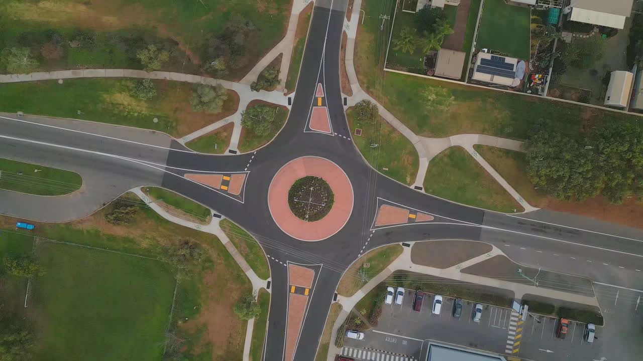 Aerial footage of traffic at a roundabout in Geraldton, Perth, Western Australia. The footage revolves around the roundabout as light traffic goes through the road intersection