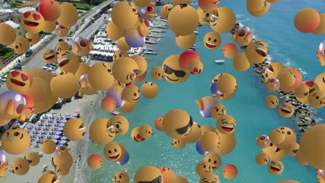 Digital-composition-of-multiple-face-emojis-floating-against-aerial-view-of-the-beach