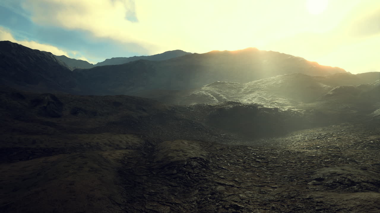 Mountains bathed in golden sunlight near a rocky landscape at dusk