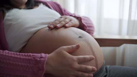 happy pregnant woman and expecting baby at home.