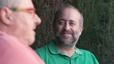 two men conversing outdoors