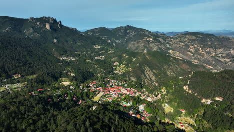 drone flying away from the mineral del chico village, in sunny hidalgo, mexico