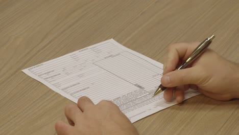 car salesman showing a customer where to sign the bill of sale for the purchase of a vehicle