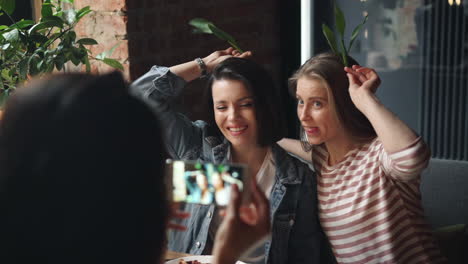 friends taking a selfie in a cafe