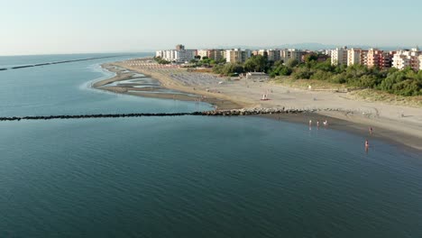 aerial shot of sandy beach with umbrellas, typical adriatic shore