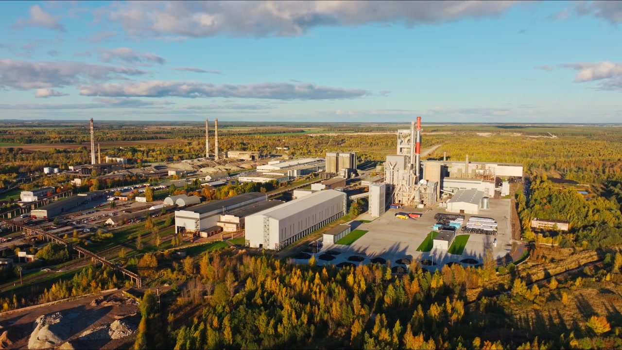 Cinematic Side Flight Over Naujoji Akmene Industrial Autumn View Sunlight