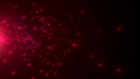pequeñas partículas rojas y estrellas en fondo oscuro