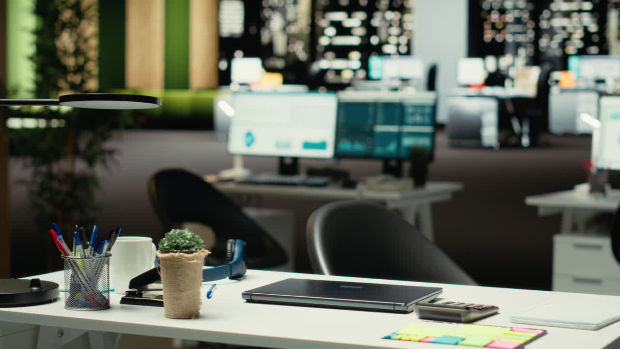 Black businesswoman closing her laptop at the office workstation