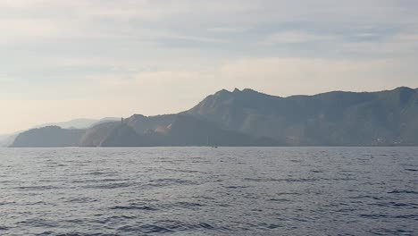 looking at rei jesus statue in the distance, early morning sunlight, travel to remote tropical island from capital dili, timor leste, southeast asia