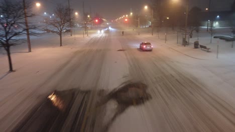 cars driving through snowy road at night in canada