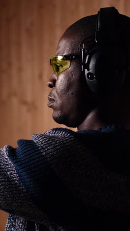 vertical video portrait of happy shooting range customer reloading pistol, close up