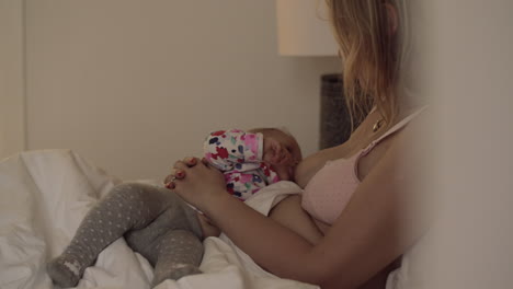 newborn baby nursing on the bed