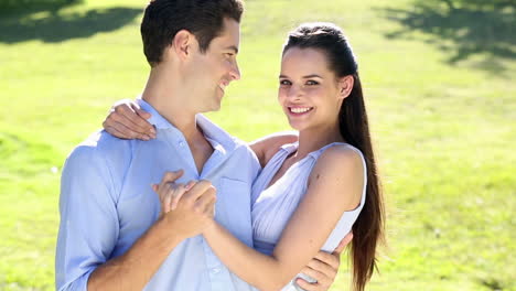 happy couple dancing in the park