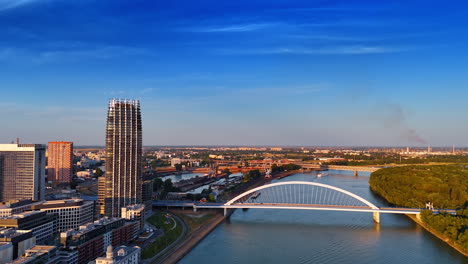 flight over the danube approaching the appolo bridge. scenery of bratislava, slovakia at sunset time