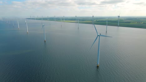 huge windmill turbines, offshore windmill farm in the ocean westermeerwind park , windmills isolated at sea on a beautiful bright day netherlands flevoland noordoostpolder