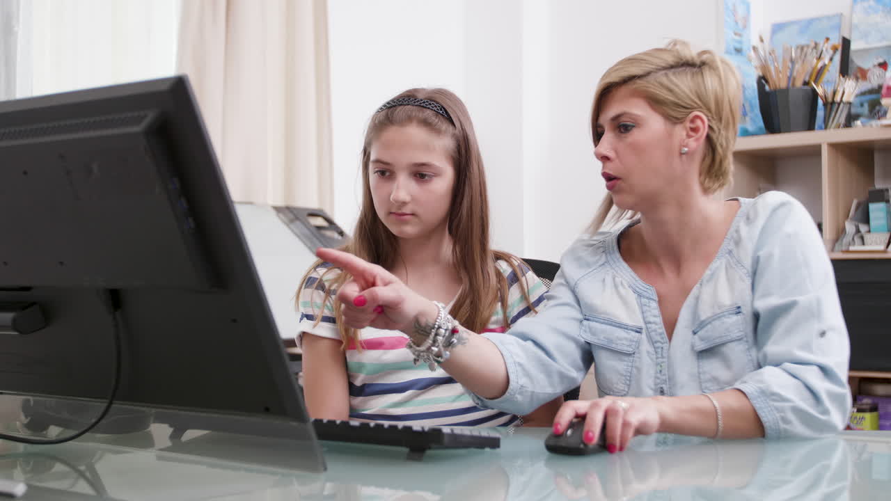 Mother and Daughter Working on Computer