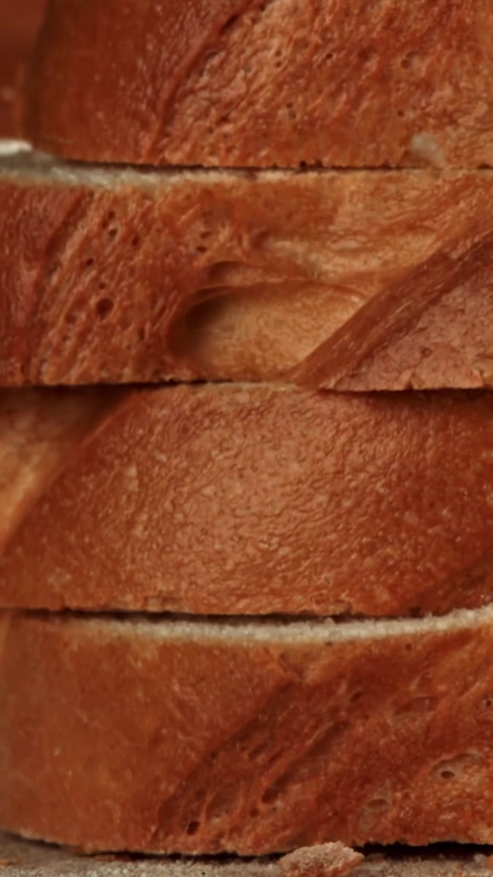 Fresh Bread Slices Falling and Stacking in Slow Motion