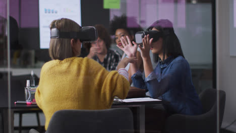 diverse work colleagues sitting in meeting room wearing virtual reality glasses