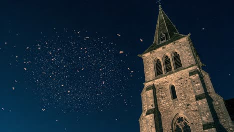 a captivating nighttime display of petals floating gracefully around an historic church, creating an enchanting atmosphere under the starry sky