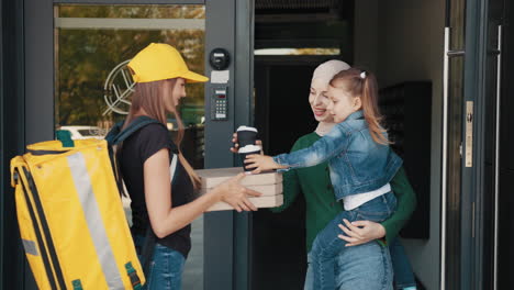 family receiving pizza delivery