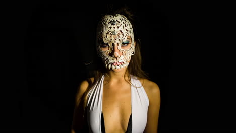 a woman with ornate venetian skull mask over face