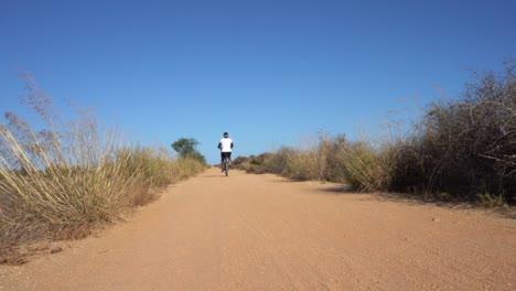 black woman riding a bike on a terrain path