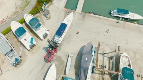 aerial top down shot of a boat parking, car moving a boat, cartagena, colombia