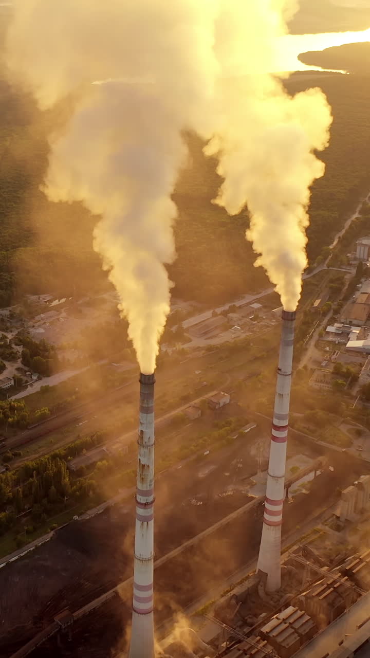 Factories pollute the environment continuously. Industry pipes pollute the atmosphere with smoke. Vertical video