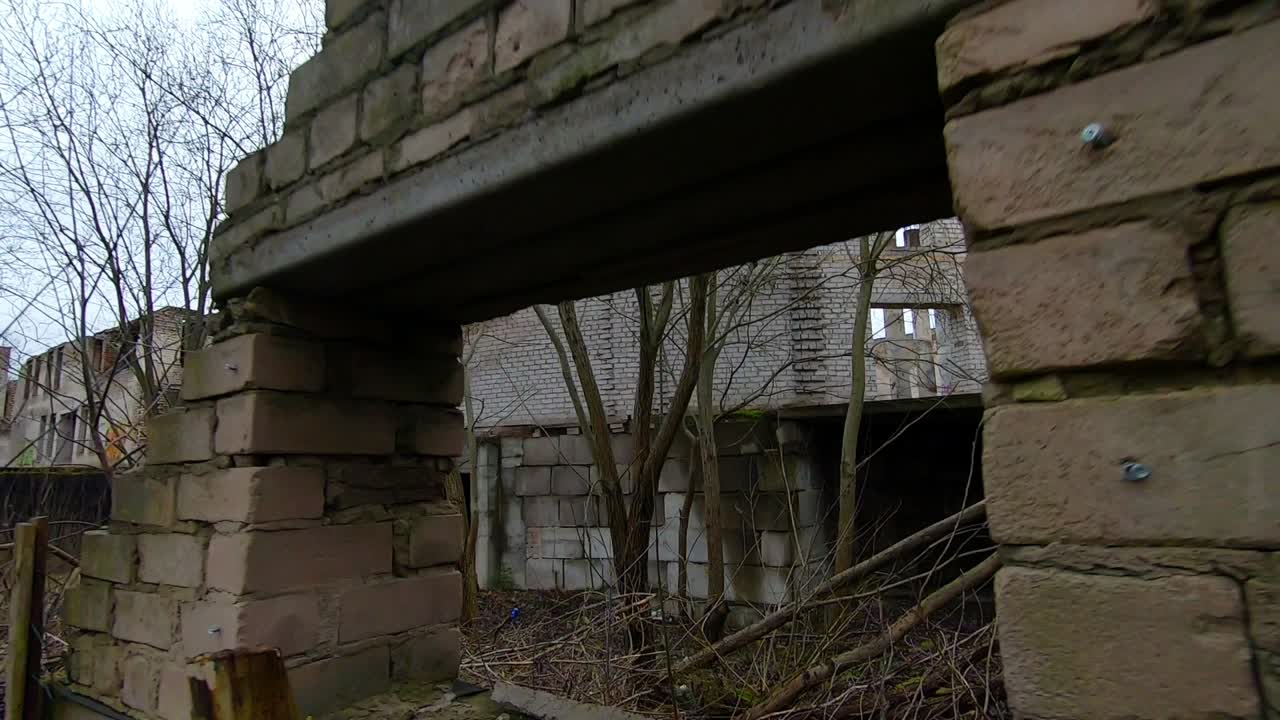 Abandoned White Brick Building. Dolly Out Slow Motion Shot