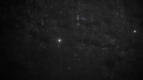 rain and fly glitters on dark wall texture