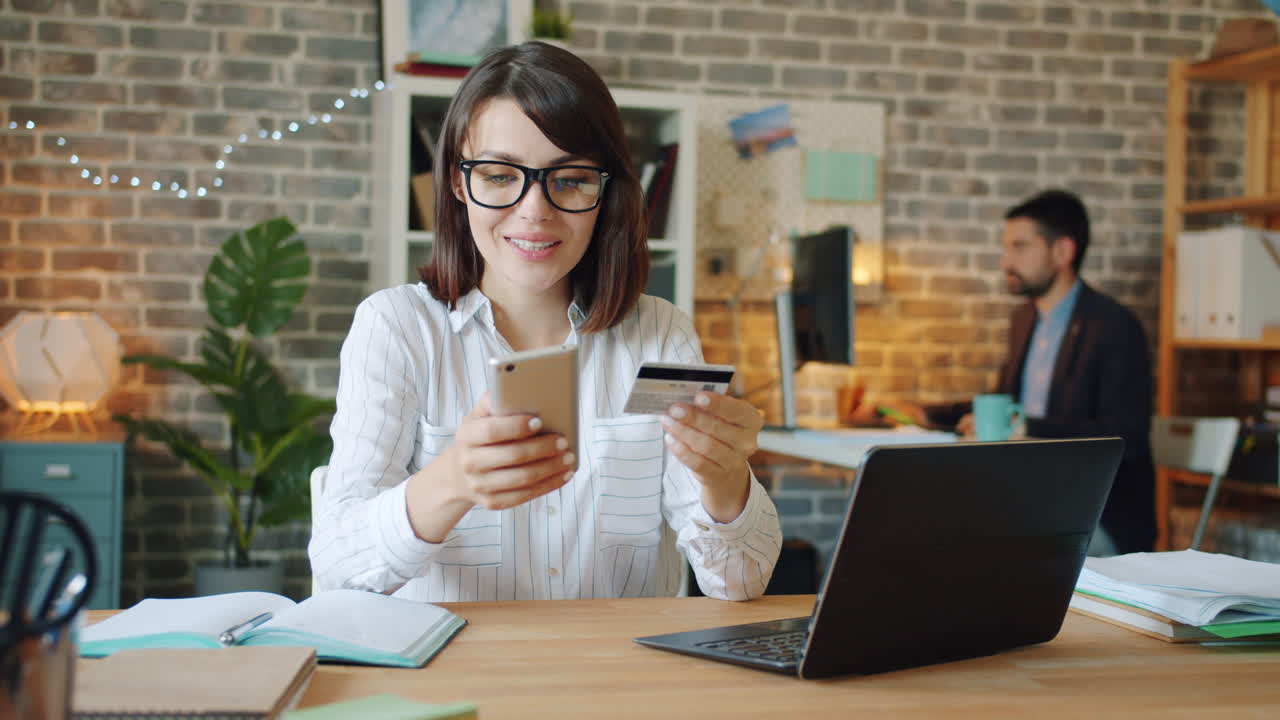 Woman Making Online Payment in Office