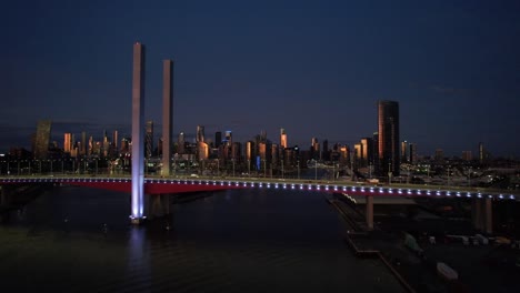 golden city melbourne aerial sideways bolte bridge in blue lights