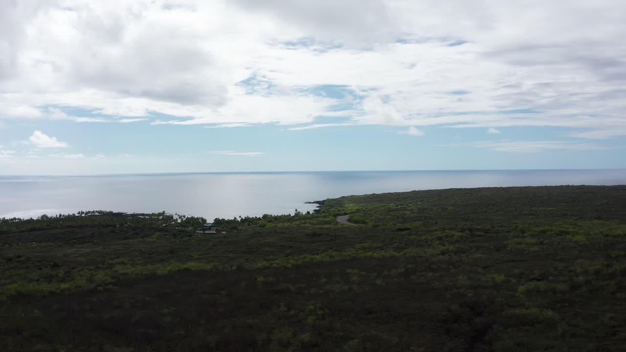 Aerial wide rising shot of Honaunau Bay with Pu'uhonua O Honaunau National Historical Park along the coastline of the Big Island of Hawai'i