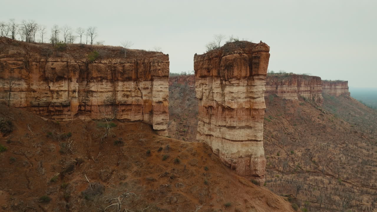 Aerial drone footage of the iconic Chilojo Cliffs in Gonarezhou National Park, Zimbabwe. Dramatic sandstone escarpment rising above the savanna part 5